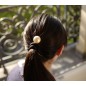 Elastique cheveux ou bracelet noir avec grosse perle nacré cloûté Elastique cheveux ou bracelet noir avec grosse perle nacré cloûté