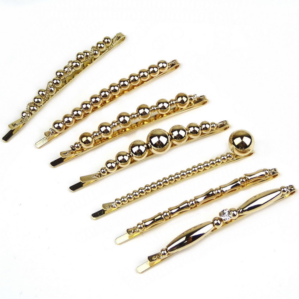 Pince à cheveux fine motif torsadé et perles dorées