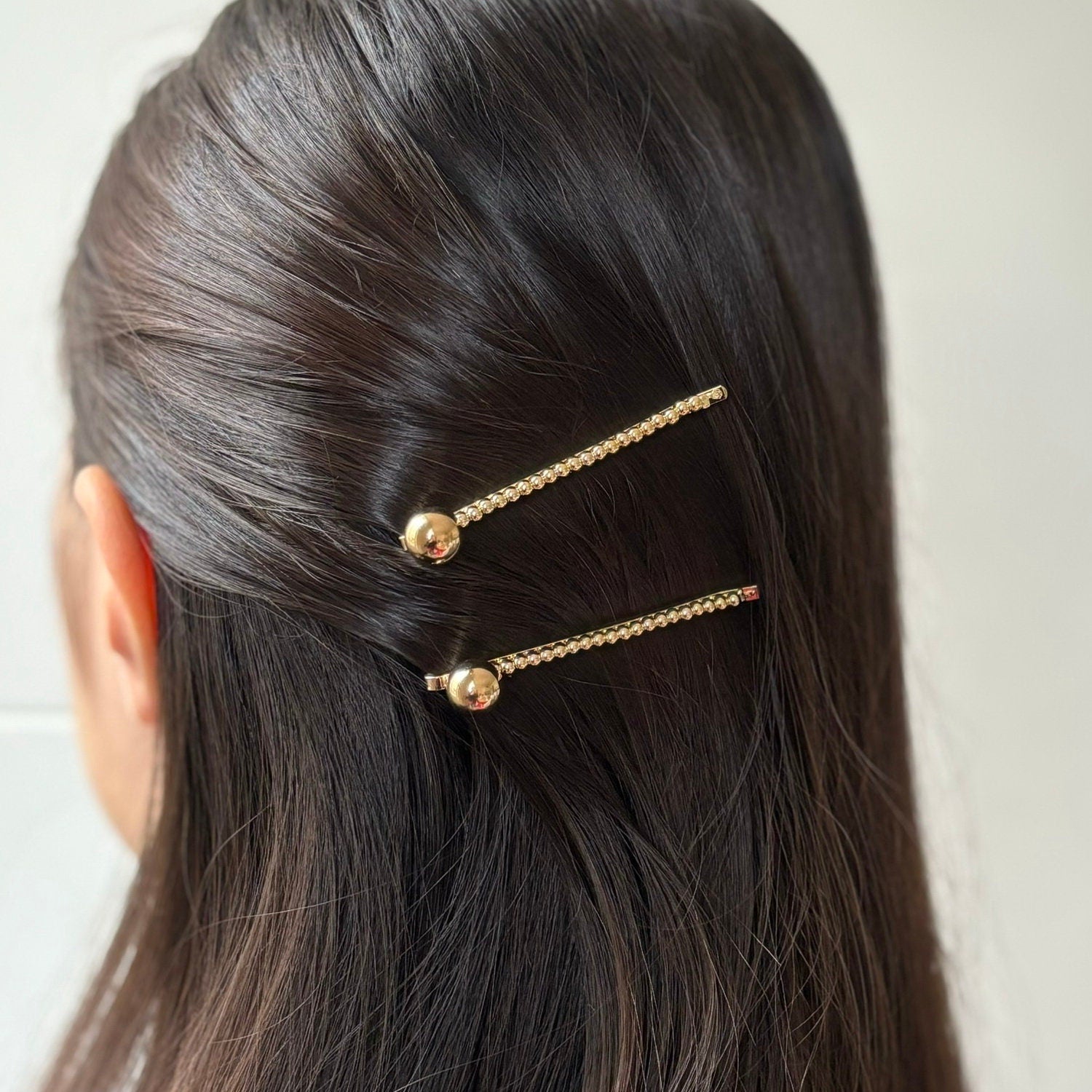 Pince cheveux avec boule en métal doré