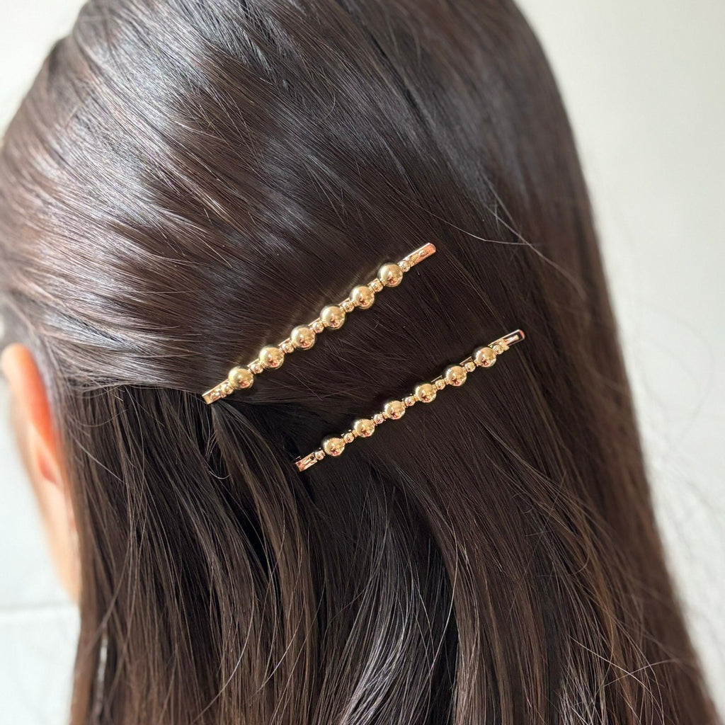 Pince cheveux motif torsadé et perles rondes dorées
